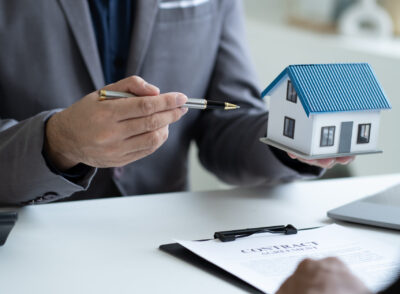 Close up Real Estate agent explain signing agreement for buying house. Bank manager and real estate concept.