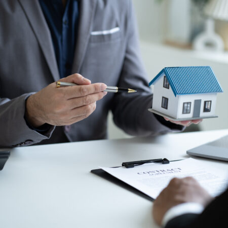 Close up Real Estate agent explain signing agreement for buying house. Bank manager and real estate concept.